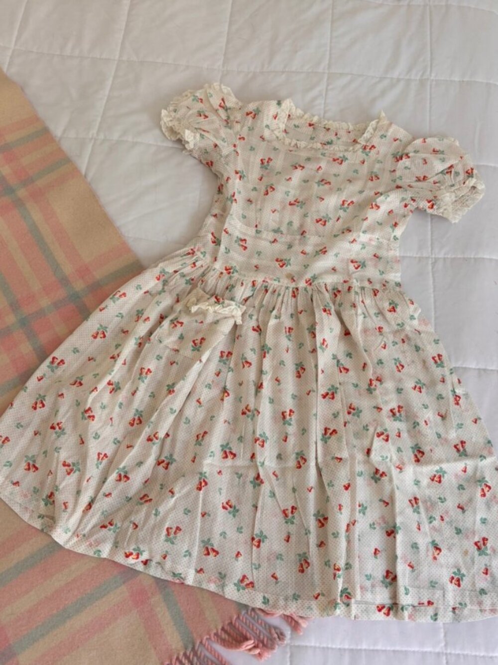 Vintage white cotton Childs dress with floral print, featuring short puff sleev.